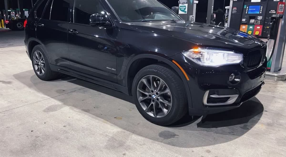 The same BMW X5 after a full chrome delete, every trim piece blacked out
