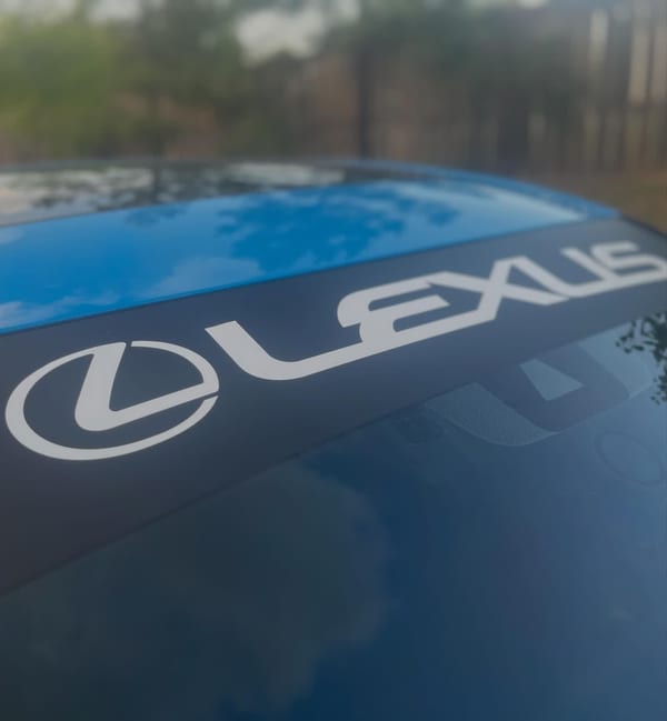 Custom-cut Lexus windshield banner on a gloss blue color change wrap